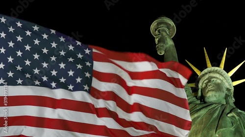 Statue of Liberty at Night. With USA Flag waving in New York, USA. Close up