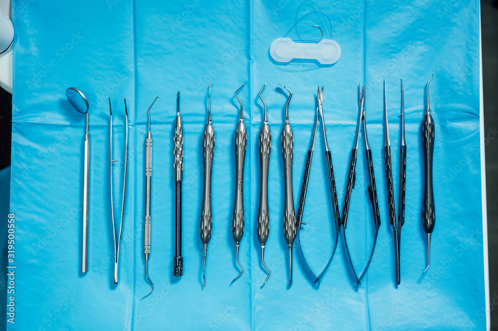 Detail of hand holding dental tools in dental clinic. Dental clinic. Detail of hand holding dental tools in dental clinic. Dental clinic.