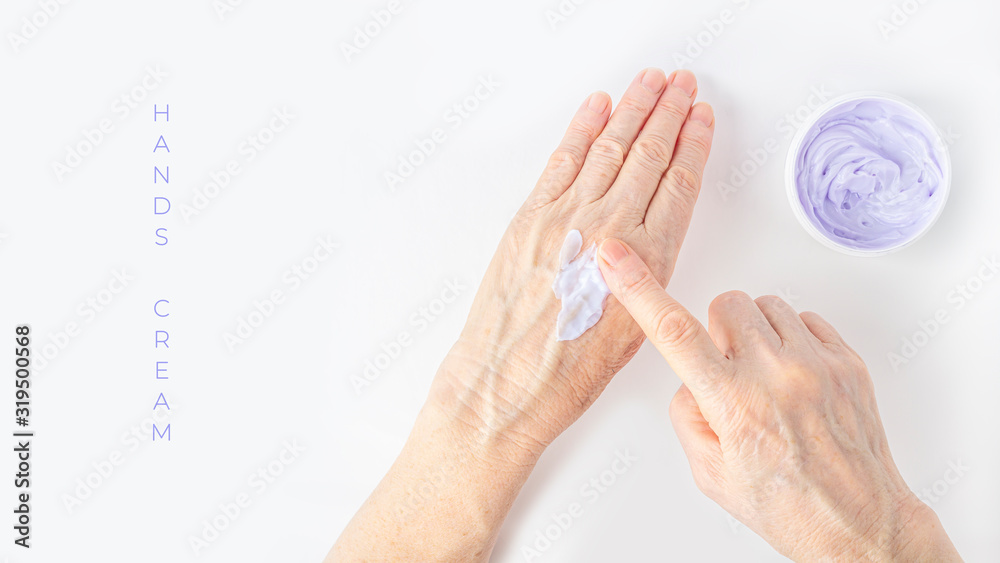 Elderly woman creaming her hands close up. Cosmetic moisturizing care for old skin. Anti-aging hand care and treatment. Ointment for the treatment of joints for the elderly. Elderly woman creaming her hands close up. Cosmetic moisturizing care for old skin. Anti-aging hand care and treatment. Ointment for the treatment of joints for the elderly.