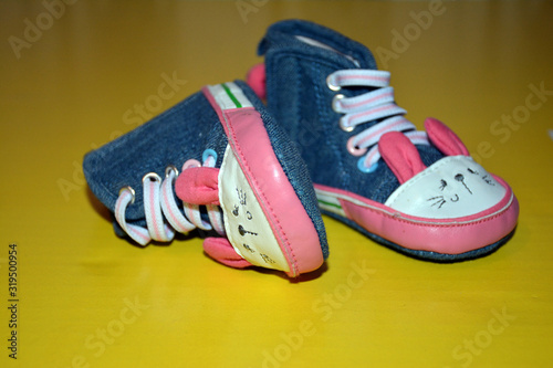 Blue kids shoes with pink soles and pink and white laces. Stylish baby. Fashion footwear. Children's sports shoes. Fashion