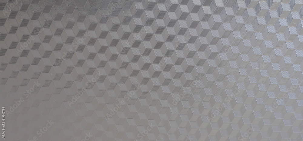 Fototapeta premium Reflective metal surface. Reflective gray metal with diamond shaped triangles