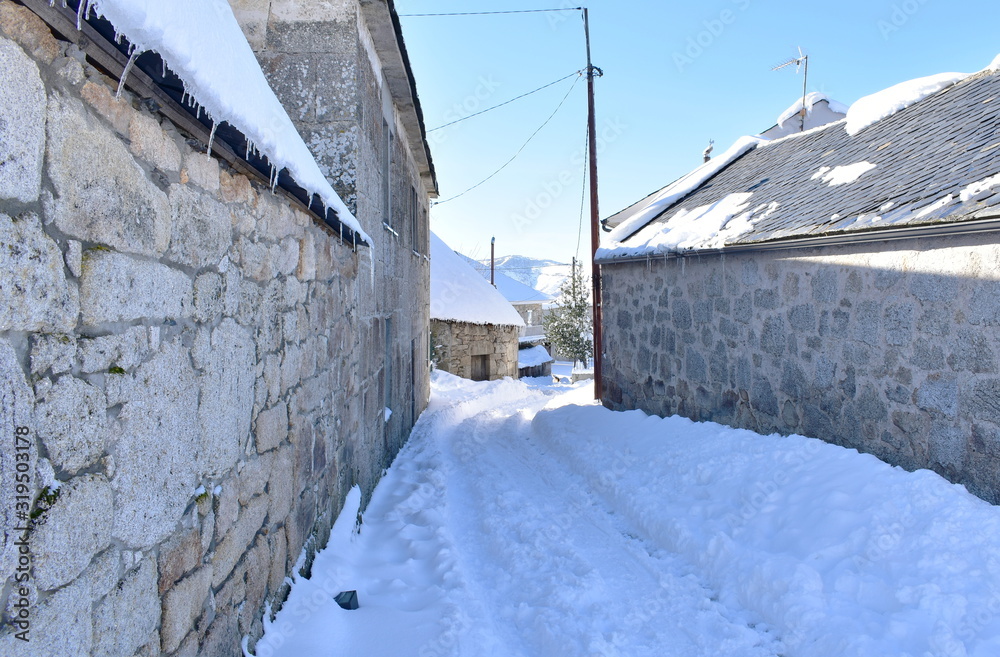 Famous Piornedo mountain village after a snowfall with ancient round Palloza stone houses with thatched roofs. Ancares, Lugo, Galicia, Spain.