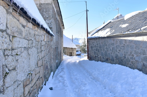 Famous Piornedo mountain village after a snowfall with ancient round Palloza stone houses with thatched roofs. Ancares, Lugo, Galicia, Spain. © JB