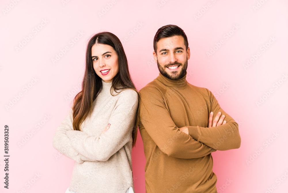 Fototapeta premium Young caucasian couple isolated who feels confident, crossing arms with determination.