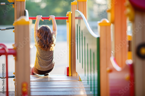 Little kid on playground, children's slide photo