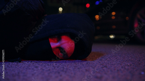 Young face man ganster lying on ground police caught a bandit silen light in the dark at night police protection arrest balaclava crowbar dangerous defense handcuffs masked people person violence photo