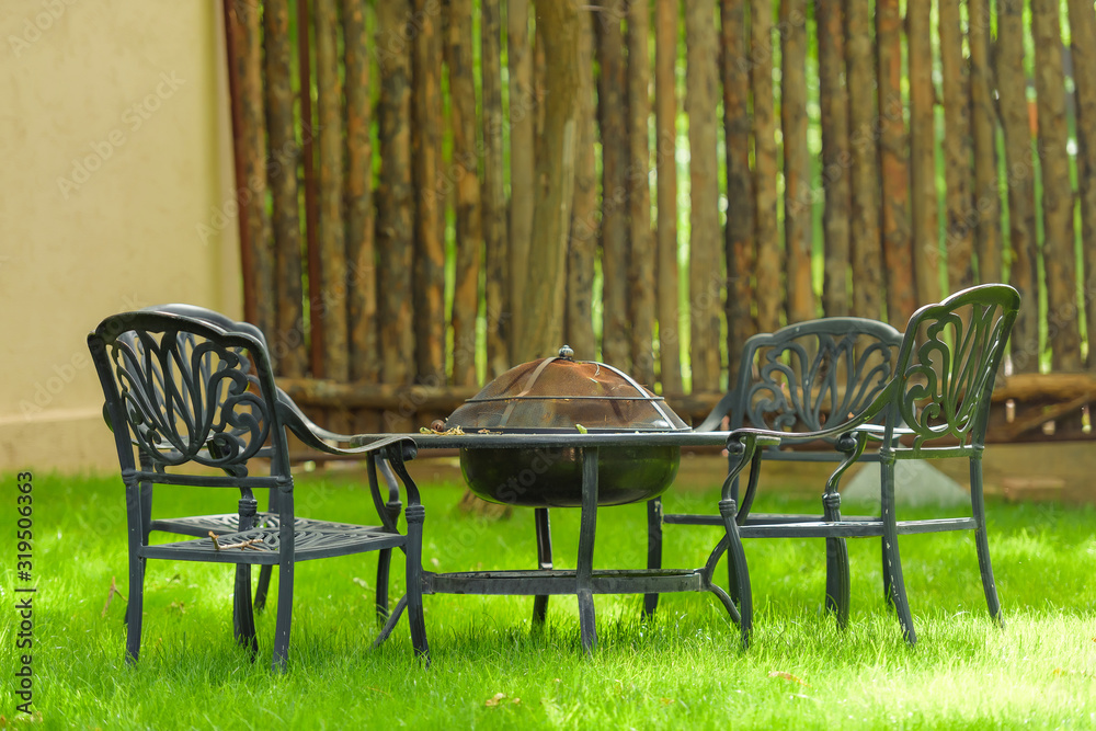 Garden furniture with builtin barbecue hearth fireplace in the table