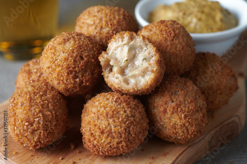 Bitterballen are a Dutch meat-based snack, made by making a very thick stew thickened with roux and beef stock and generously loaded with meat. photo