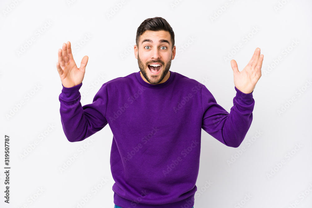Young caucasian man against a white background isolated receiving a pleasant surprise, excited and raising hands. Young caucasian man against a white background isolated receiving a pleasant surprise, excited and raising hands.