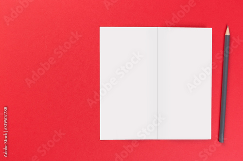 top view of blank open notebook on red background, office equipment, school supplies and education concept