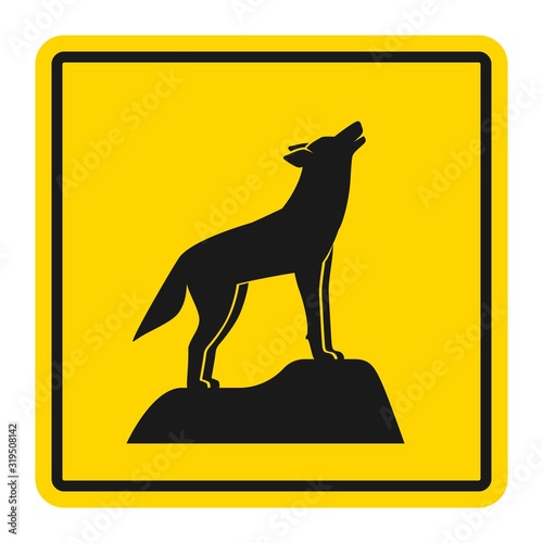 Wild animals yellow road sign. Silhouette of howling wolf