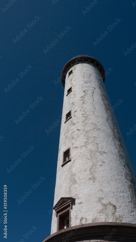 Many midges fly over lighthouse Erik, North of the island Oland in Sweden