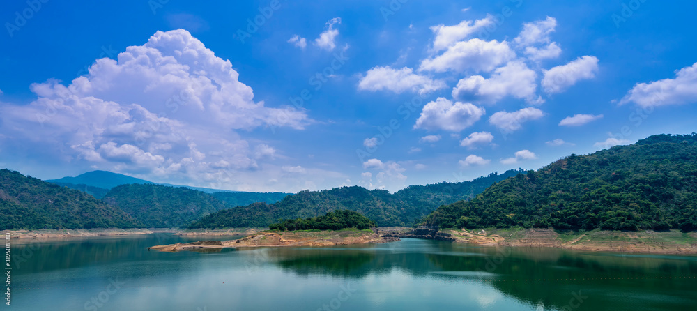 Beautiful view water in lake and high mountain with blue cloudy sky behind khun dan prakan chon dam in nakhon nayok province thailand