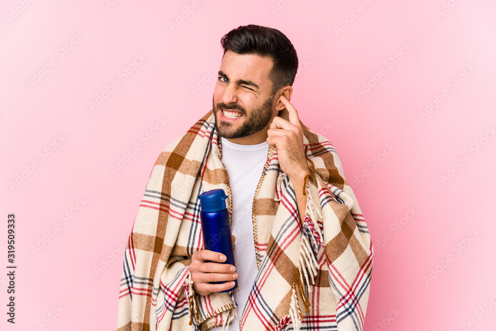 Fototapeta premium Young man in a camping isolated covering ears with hands.