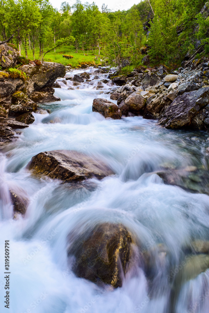 Blurry motions water of river. .River along the Aurlandsfjellet mountains in Norway.