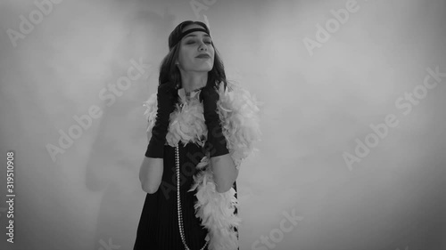 Footage video of Roaring twenties Gatsby,  flapper party girl, vintage 20's fashion style and make up and hairstyle, costume, model young woman, Caucasian girl