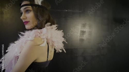 Footage video of Roaring twenties Gatsby,  flapper party girl, vintage 20's fashion style and make up and hairstyle, costume, model young woman, Caucasian girl