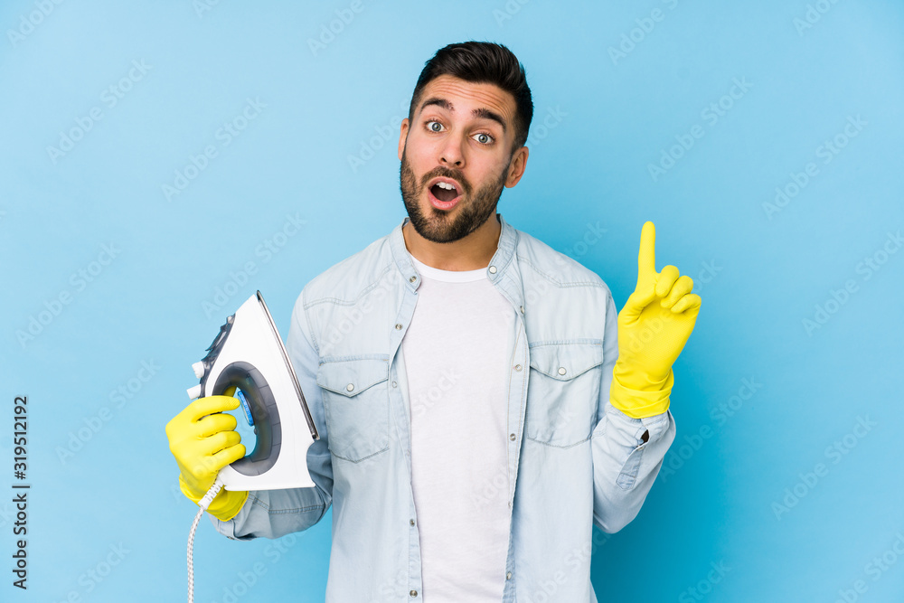 Portrait of young man ironing isolated having some great idea, concept of creativity. Portrait of young man ironing isolated having some great idea, concept of creativity.