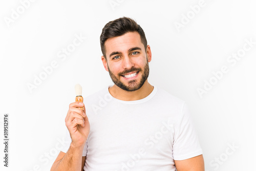 Young caucasian man recently shaving isolated happy, smiling and cheerful.