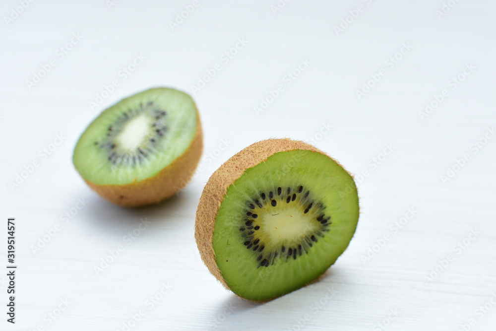 Fresh whole kiwi and half kiwi showing its texture Fresh whole kiwi and half kiwi showing its texture