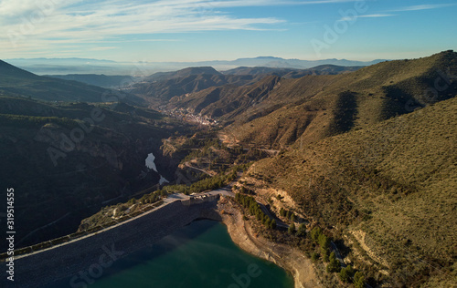 Aerial photography Embalse de Canales Reservoir in Guejar Sierra, province of Granada, Andalusia, Spain. Picturesque nature green hills and turquoise clear water view from above. Spain © Alex Tihonov