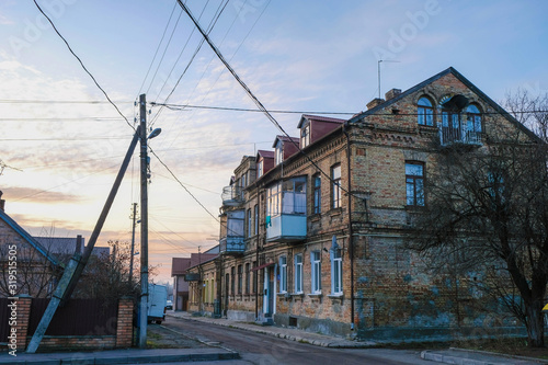 Sunset in the old town. Residential building of the early nineteenth century in Lutsk, Ukraine. Deserted street.