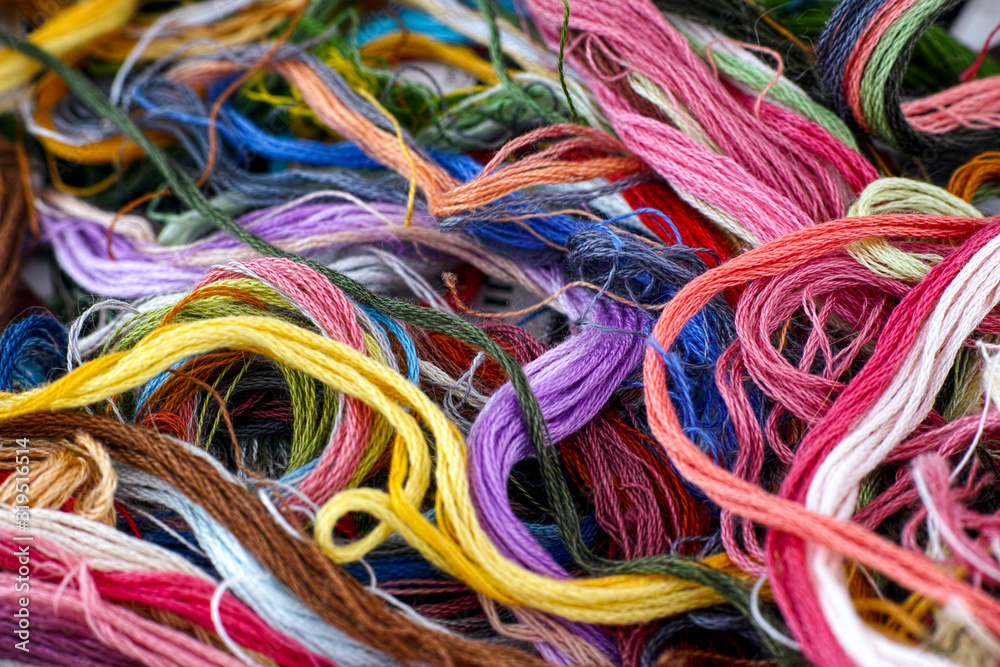 Backgrounds of colored embroidery threads.