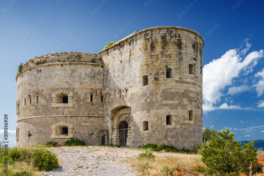 Sunny view of ancient fort on the background of Kotor bay from Lustica peninsula, Montenegro.