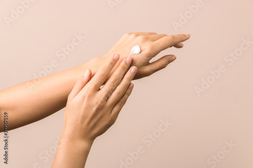 skincare. close up view of woman hand moisturising them with cream. skincare photo