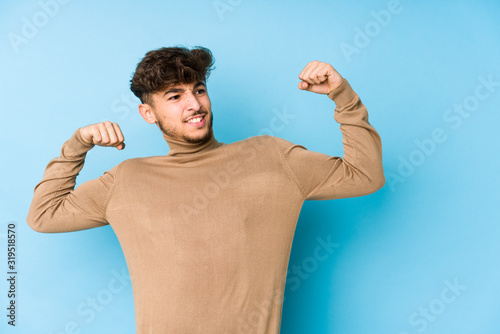 Young arabian man isolated raising fist after a victory, winner concept.