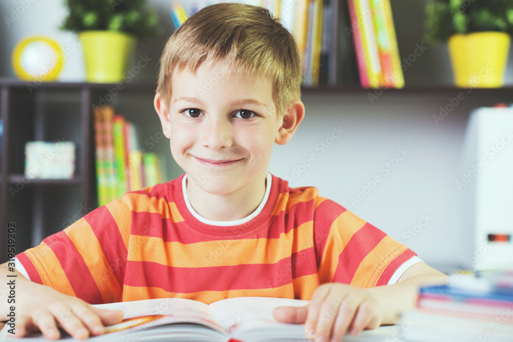 School boy at classroom desk making schoolwork School boy at classroom desk making schoolwork