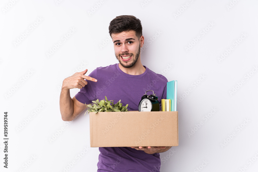 Young caucasian man moving a new home isolated person pointing by hand to a shirt copy space, proud and confident Young caucasian man moving a new home isolated person pointing by hand to a shirt copy space, proud and confident