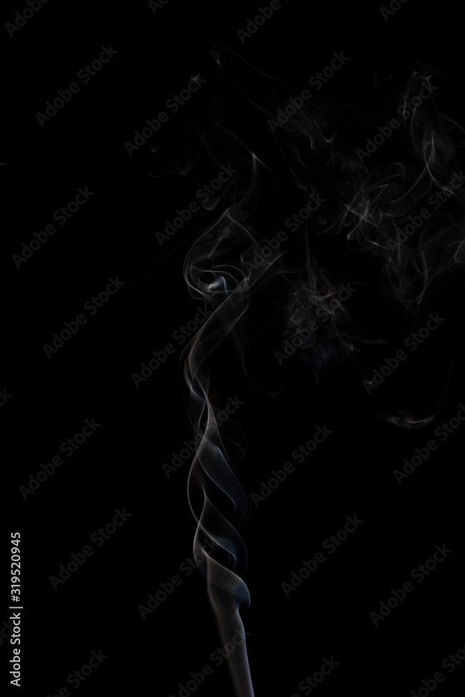 Delicate column of smoke from incense stick isolated on black background, selective focus Delicate column of smoke from incense stick isolated on black background, selective focus