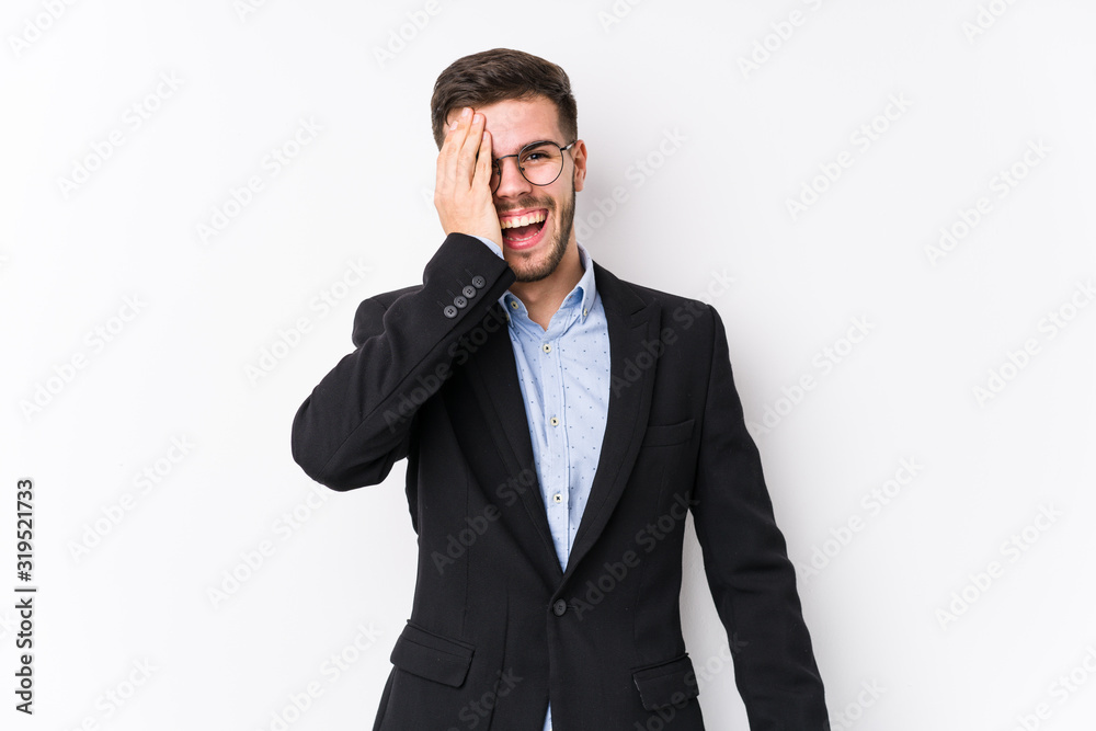 Young caucasian business man posing in a white background isolated Young caucasian business man having fun covering half of face with palm. Young caucasian business man posing in a white background isolated Young caucasian business man having fun covering half of face with palm.