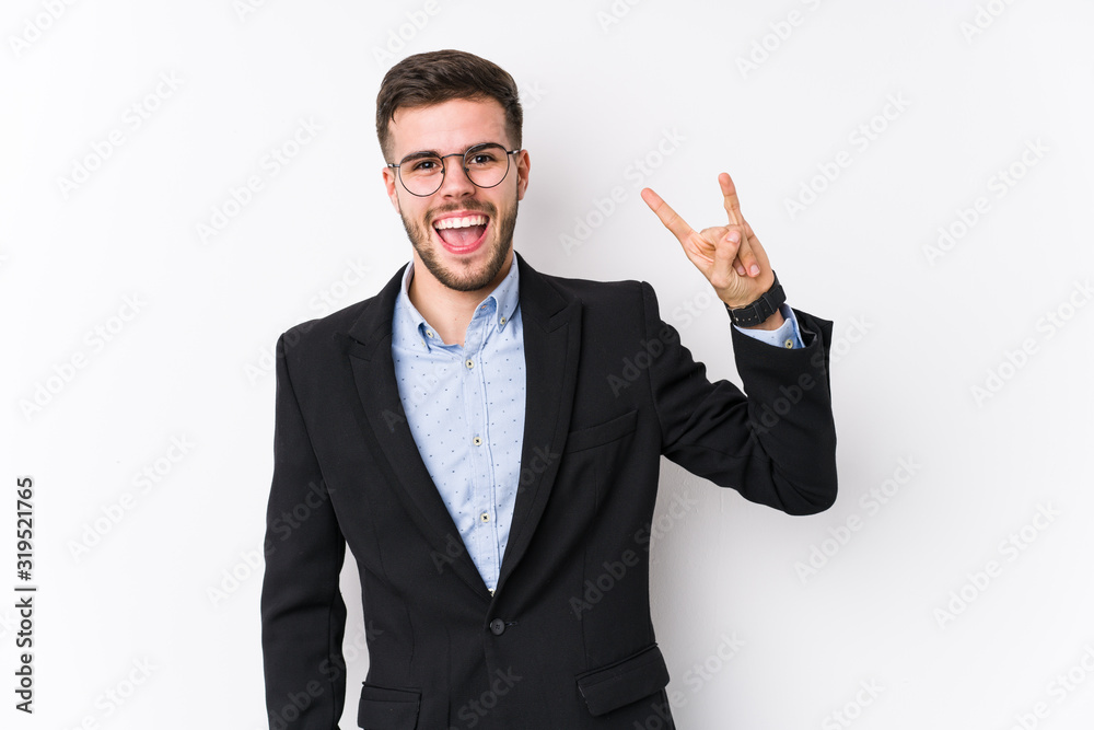 Young caucasian business man posing in a white background isolated Young caucasian business man showing a horns gesture as a revolution concept. Young caucasian business man posing in a white background isolated Young caucasian business man showing a horns gesture as a revolution concept.