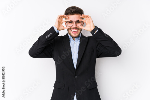 Young caucasian business man posing in a white background isolated Young caucasian business man showing okay sign over eyes