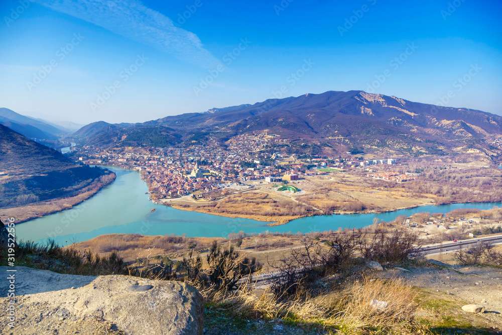 Georgia, Mtskheta, the confluence of the Kura and Aragvi rivers, a muddy and clear river. The view from the Jvari monastery. Caucasian mountains, monasteries. 