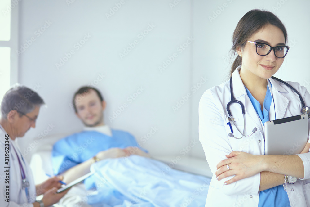 Doctor checking heart beat of patient in bed with stethoscope Doctor checking heart beat of patient in bed with stethoscope