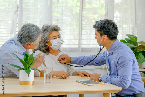 Doctor use stethoscope to check up old woman help with old man support near to woman.