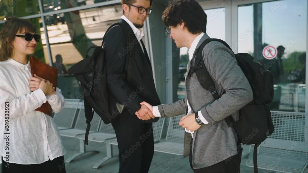 Colleagues meet and shake hands in urban environment background. Colleagues meet and shake hands in urban environment background.