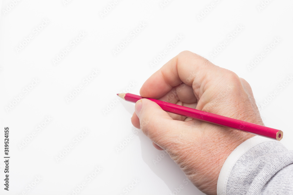 Colored pencil in the hand of an adult person Colored pencil in the hand of an adult person
