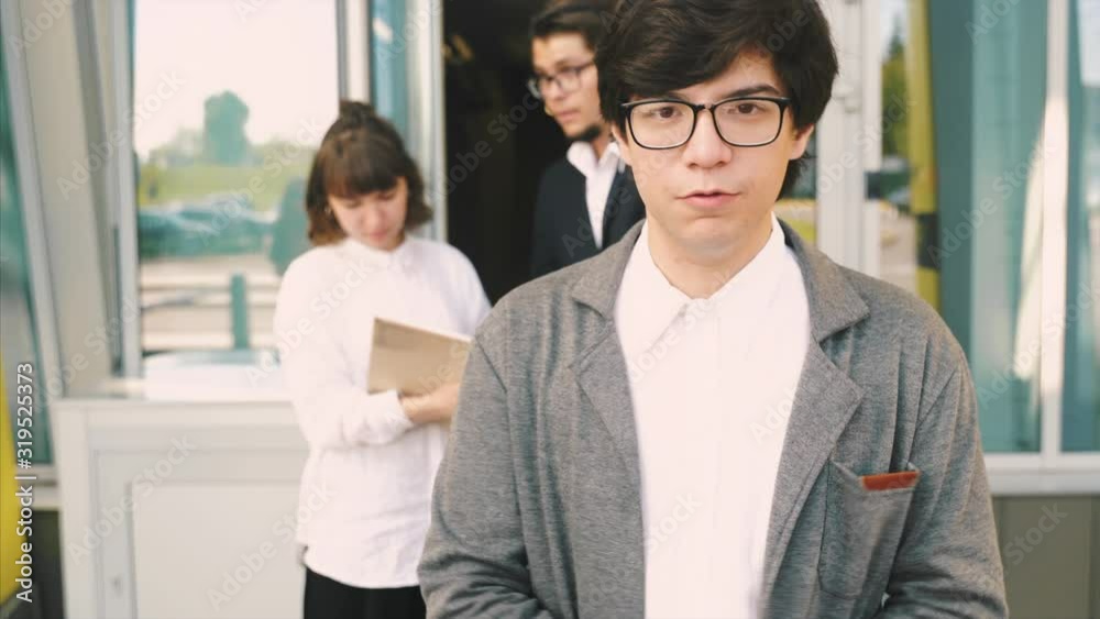 Man with glasses speaks to the camera, close angle Man with glasses speaks to the camera, close angle