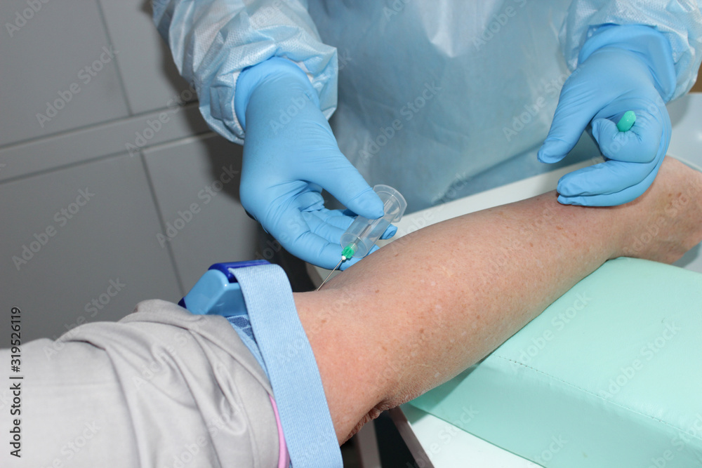 Medical topic a health worker takes blood from a patient's vein in a hospital Selective focus. Medical topic a health worker takes blood from a patient's vein in a hospital Selective focus.