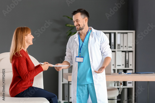 Male doctor working with pa...
