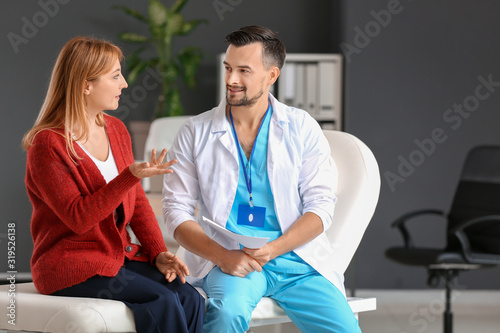 Male doctor working with pa...