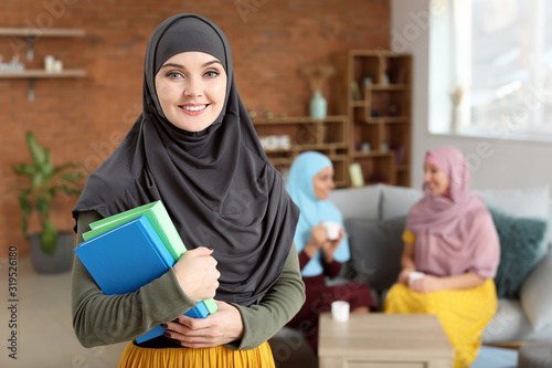 Female Muslim student at home