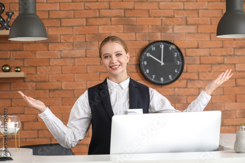 Young female receptionist a...