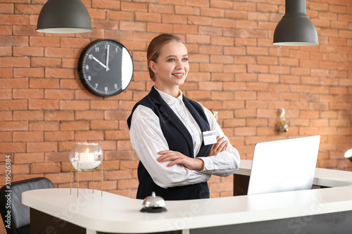 Young female receptionist a...