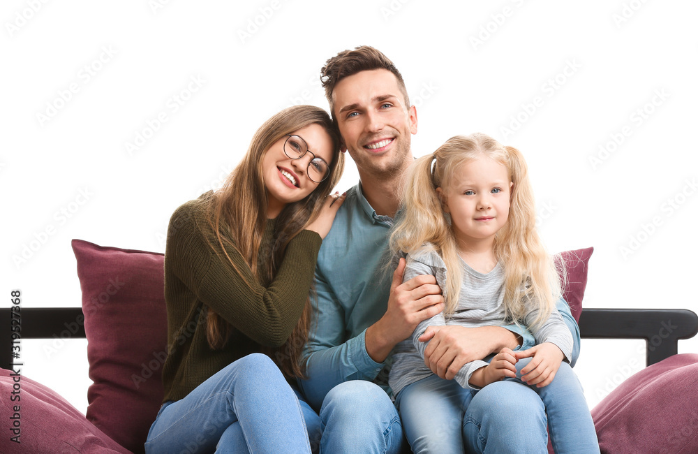 Happy young family sitting on sofa against white background Happy young family sitting on sofa against white background