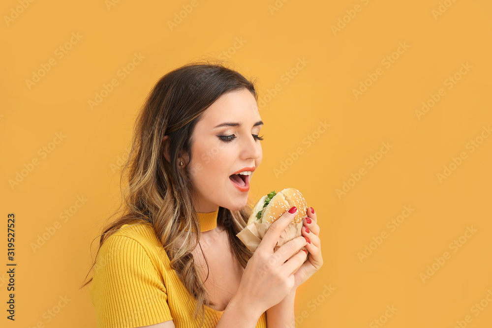 Portrait of beautiful young woman with burger on color background Portrait of beautiful young woman with burger on color background